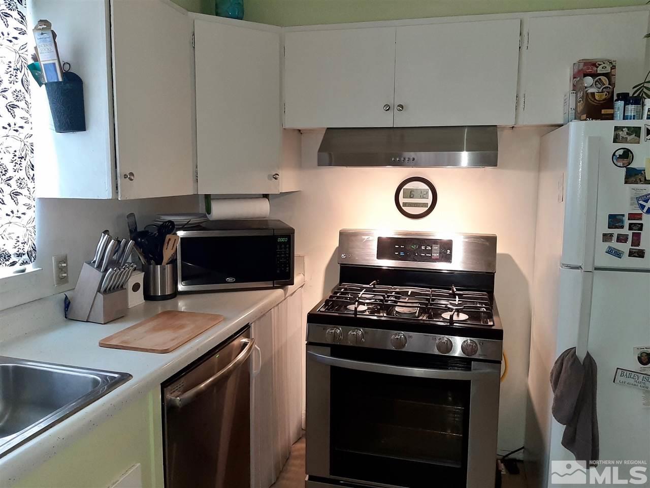 1225 Manhattan Street Reno, NV 89512 - Photo 7 of 19 a kitchen with granite countertop a stove and a sink