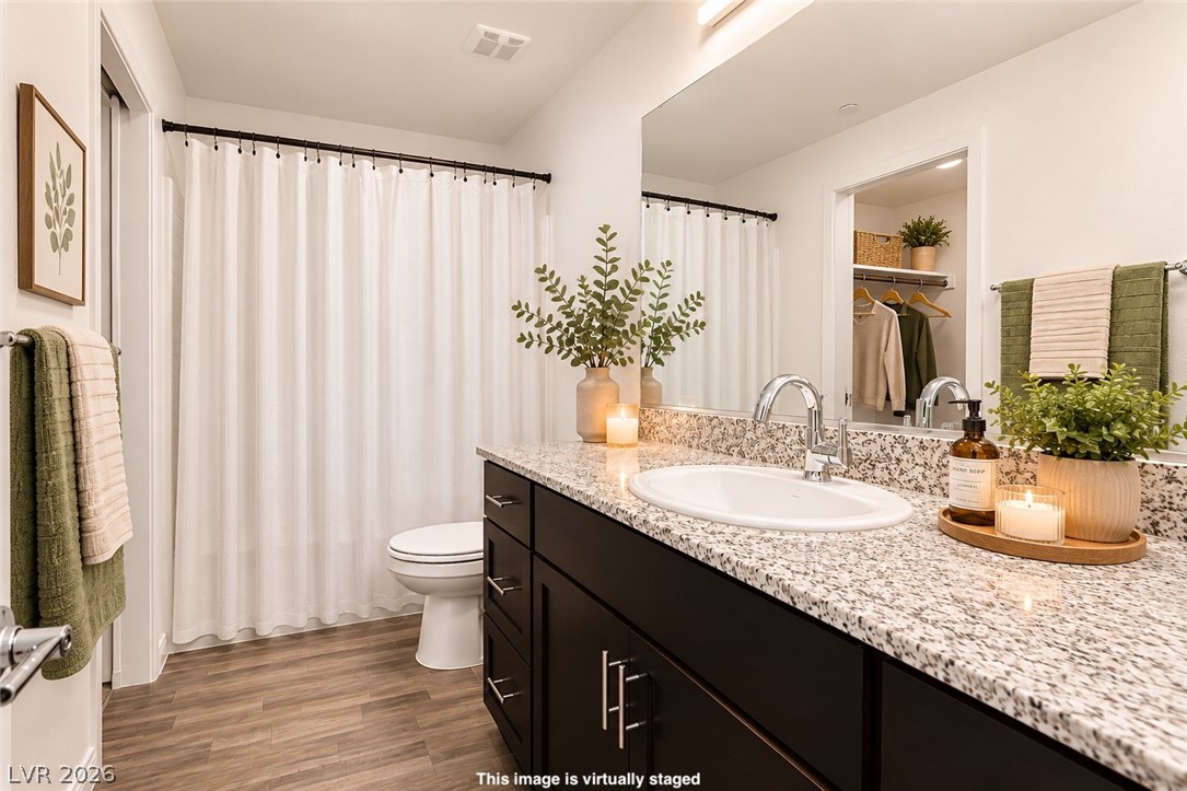 12369 Golden Wreath Road, Unit 2 Las Vegas, NV 89183 - Photo 10 of 19 Well-lit primary bathroom featuring granite counters, a single vanity, and a shower/tub combo.