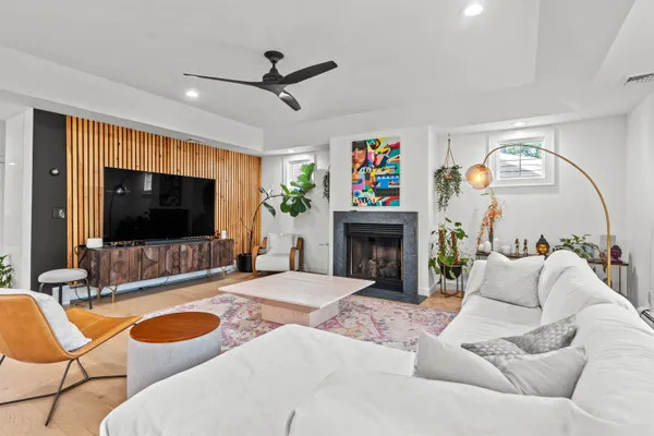 a living room with fireplace furniture and a flat screen tv