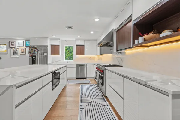 a kitchen with stainless steel appliances granite countertop sink stove and cabinets