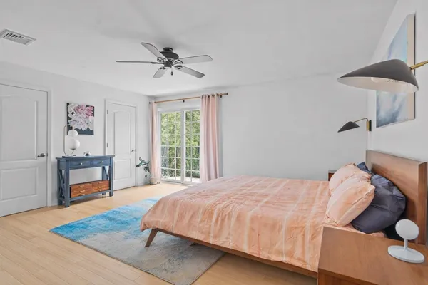 a bedroom with a bed and a chandelier