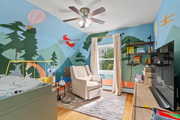 a living room with patio furniture and a flat screen tv