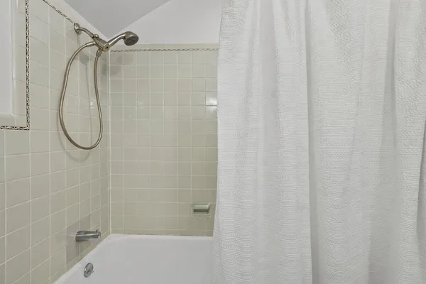 a bathroom with a shower and a shower