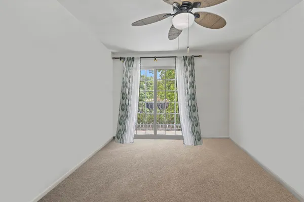 a view of room with window and ceiling fan