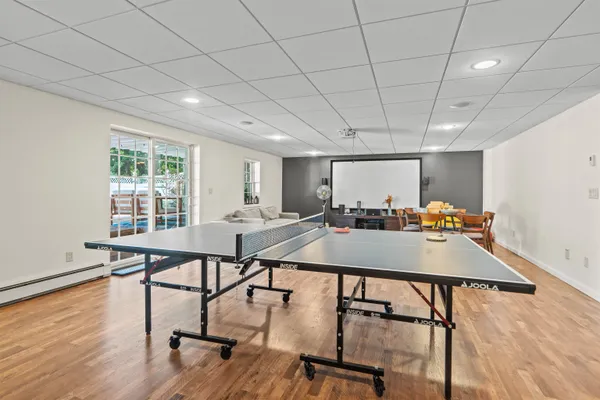 a room with furniture pool table and windows