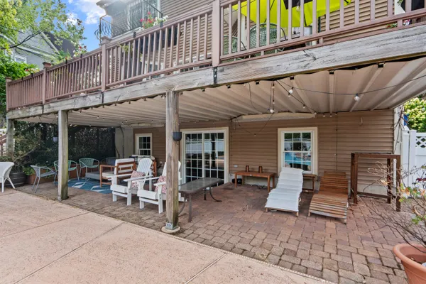 a view of a house with backyard porch and sitting area