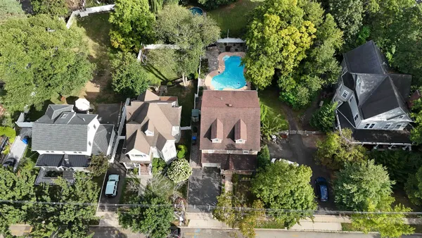 an aerial view of multiple houses with yard