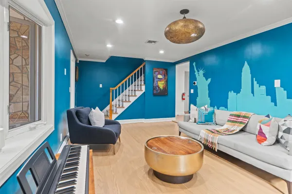 a living room with furniture and a wooden floor