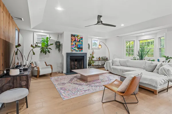 a living room with furniture a fireplace and a flat screen tv