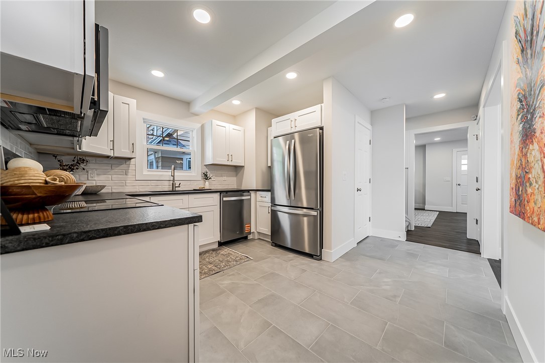 3817 Summit Park Road Cleveland Heights, OH 44121 - Photo 11 of 29 Kitchen featuring stainless steel appliances, dark countertops, recessed lighting, and a tile backsplash