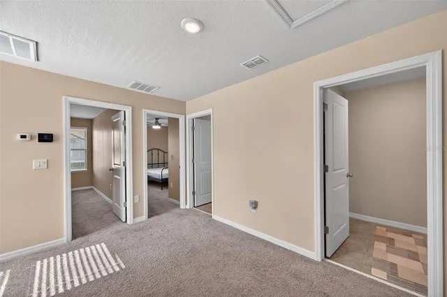 a view of a hallway with wooden shelves