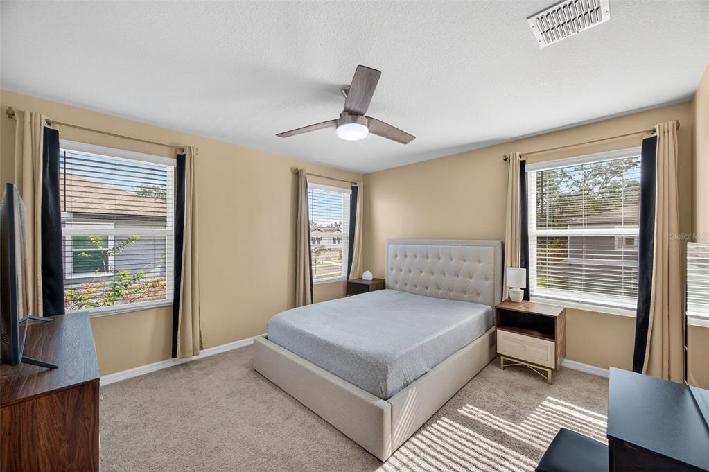 2761 Emory Sound Place Brandon, FL 33510 - Photo 13 of 27 a bedroom with a large bed and a window