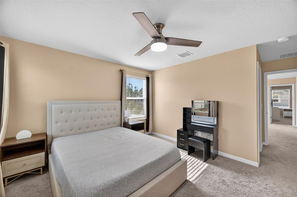 2761 Emory Sound Place Brandon, FL 33510 - Photo 14 of 27 a bedroom with a bed and a chandelier