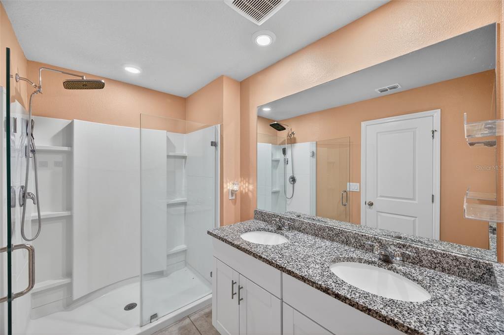 2761 Emory Sound Place Brandon, FL 33510 - Photo 16 of 27 a bathroom with a granite countertop sink a shower and a mirror