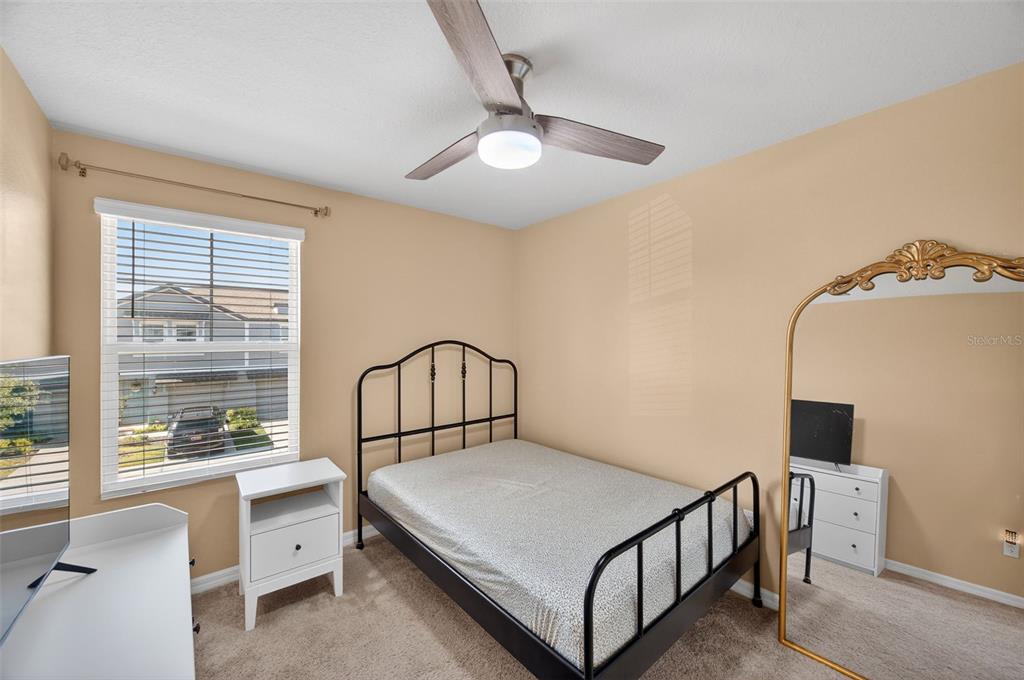 2761 Emory Sound Place Brandon, FL 33510 - Photo 19 of 27 a bedroom with a bed and a window