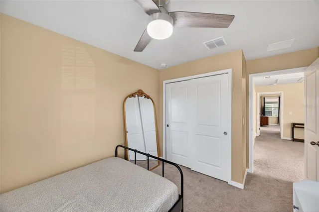 a view of a room with a ceiling fan
