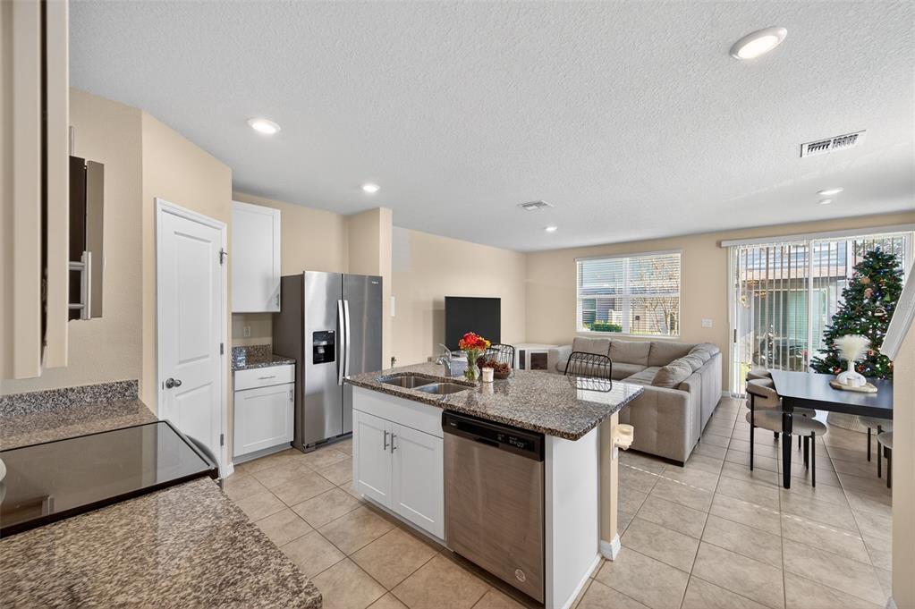 2761 Emory Sound Place Brandon, FL 33510 - Photo 3 of 27 a kitchen that has a lot of white cabinets and stainless steel appliances