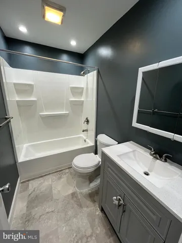 a bathroom with a bathtub and a toilet