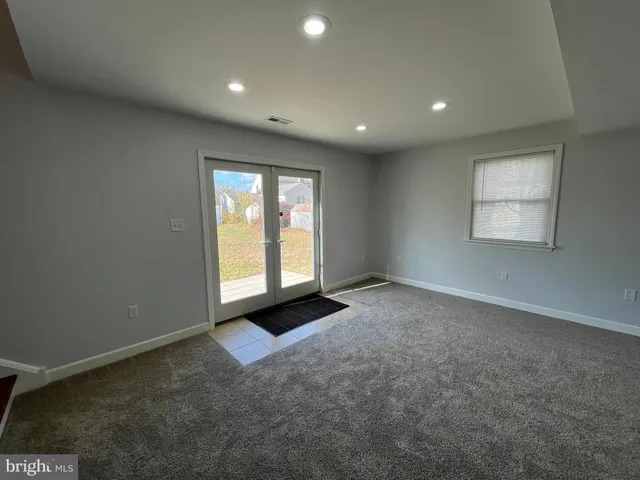 an empty room with windows and closet