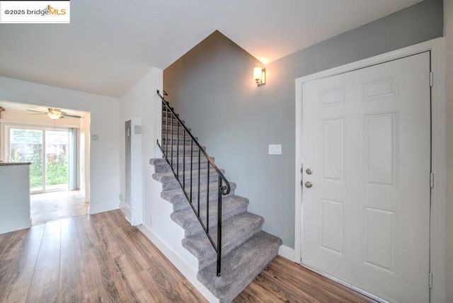 a view of entryway with wooden floor and stairs