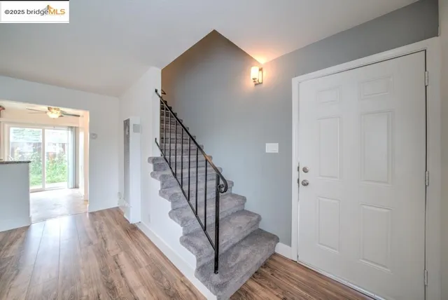 a view of entryway with wooden floor and stairs