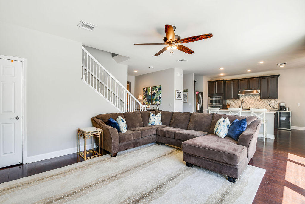 2719 Wymberly Drive Jupiter, FL 33458 - Photo 18 of 49 a living room with furniture kitchen view and a wooden floor