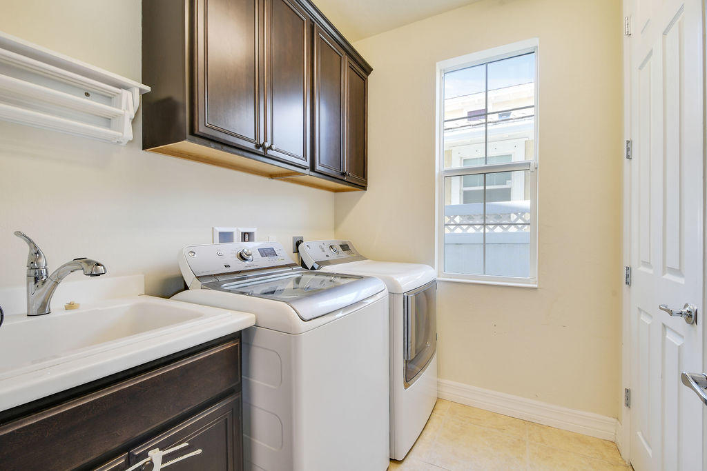 2719 Wymberly Drive Jupiter, FL 33458 - Photo 19 of 49 a utility room with dryer and washer