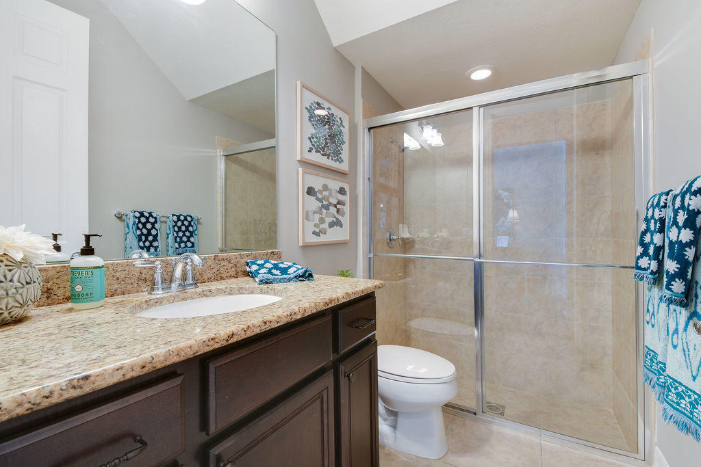2719 Wymberly Drive Jupiter, FL 33458 - Photo 20 of 49 a bathroom with a granite countertop sink toilet and shower