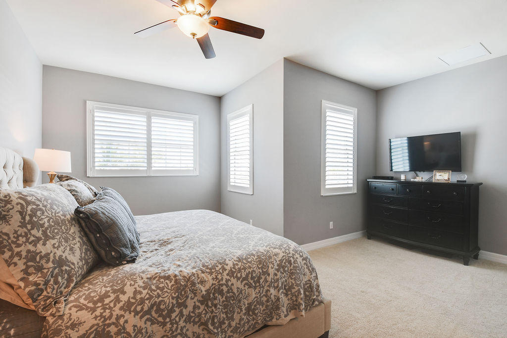 2719 Wymberly Drive Jupiter, FL 33458 - Photo 23 of 49 a bedroom with a bed and a flat screen tv