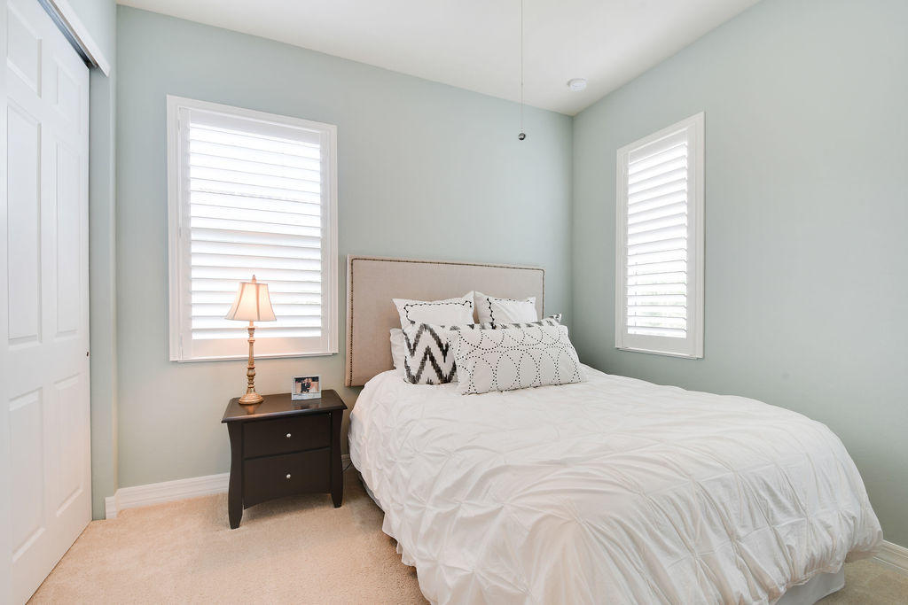 2719 Wymberly Drive Jupiter, FL 33458 - Photo 29 of 49 a bedroom with a bed and window