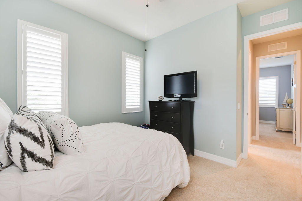 2719 Wymberly Drive Jupiter, FL 33458 - Photo 30 of 49 a bedroom with a bed and a television