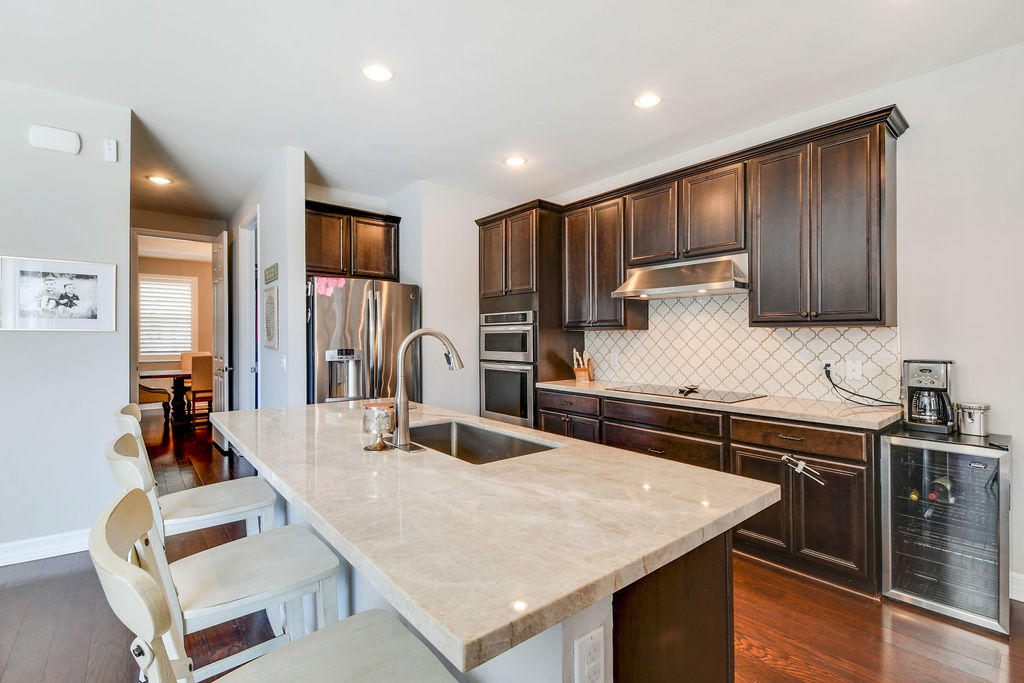 2719 Wymberly Drive Jupiter, FL 33458 - Photo 4 of 49 a kitchen with stainless steel appliances granite countertop a sink counter space and cabinets