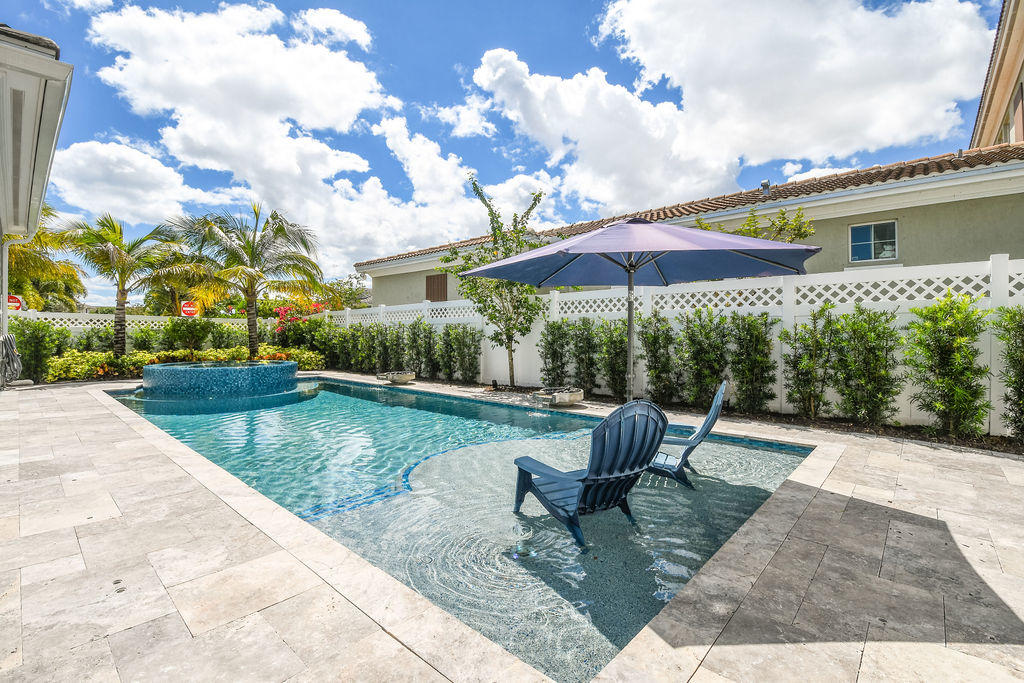 2719 Wymberly Drive Jupiter, FL 33458 - Photo 38 of 49 a view of a patio with a yard
