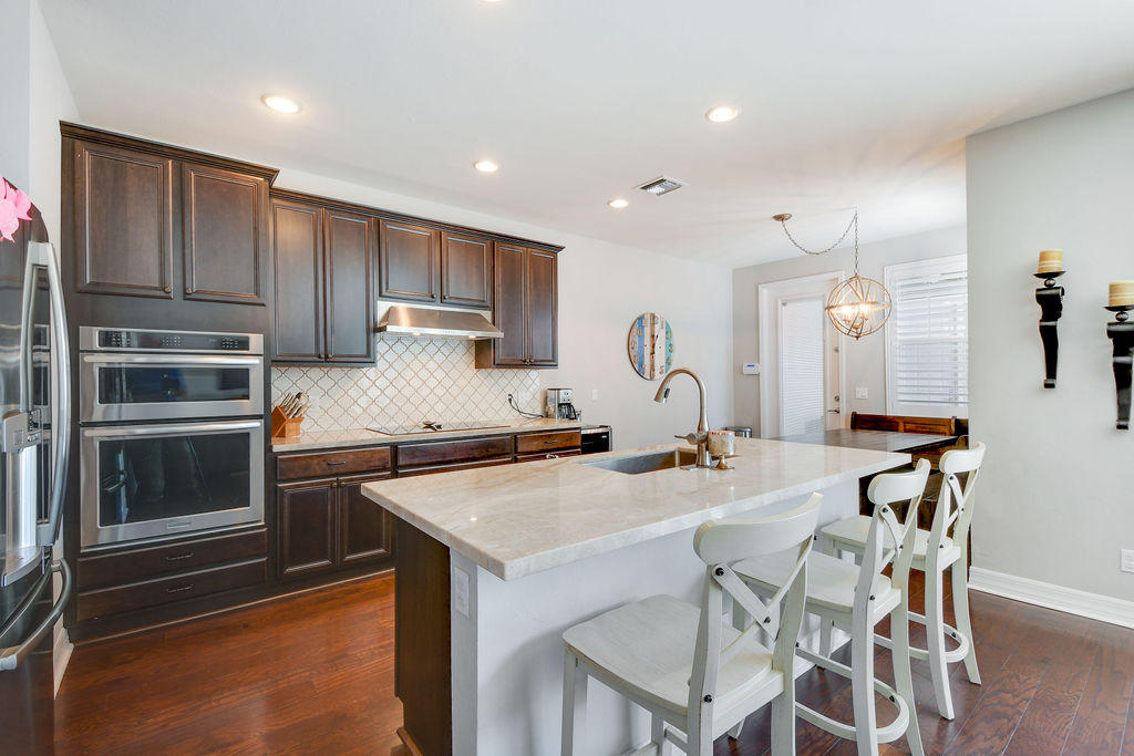 2719 Wymberly Drive Jupiter, FL 33458 - Photo 5 of 49 a kitchen with a stove a sink and a refrigerator