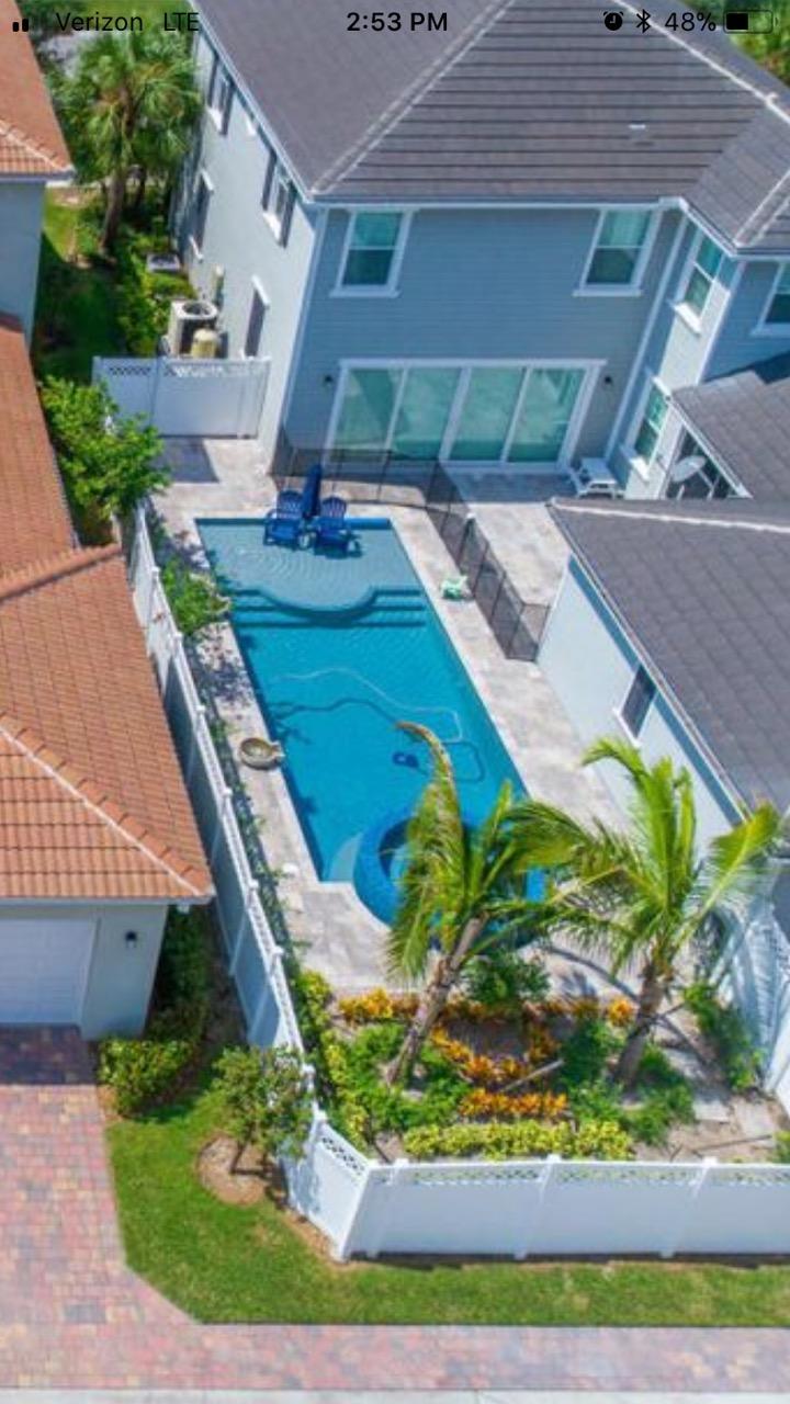 2719 Wymberly Drive Jupiter, FL 33458 - Photo 45 of 49 a view of a backyard with plants and outdoor seating