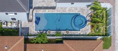 2719 Wymberly Drive Jupiter, FL 33458 - Photo 46 of 49 a front view of a house with garden