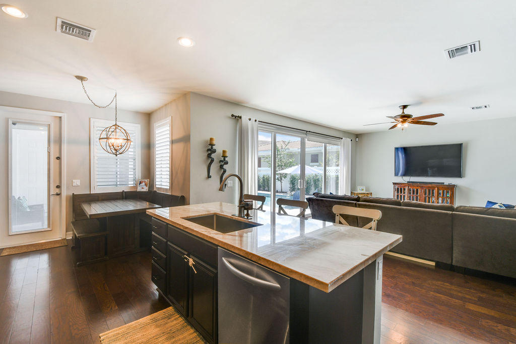 2719 Wymberly Drive Jupiter, FL 33458 - Photo 9 of 49 a kitchen with stainless steel appliances granite countertop a sink a stove and wooden floor
