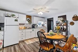 118 Constitution Street Perryopolis, PA 15473 - Photo 21 of 34 a kitchen with a dining table chairs refrigerator and cabinets
