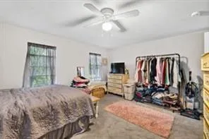 a bed room with a bed a chair and a chandelier