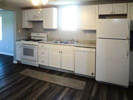 118 Constitution Street Perryopolis, PA 15473 - Photo 7 of 34 a kitchen with granite countertop white cabinets and refrigerator