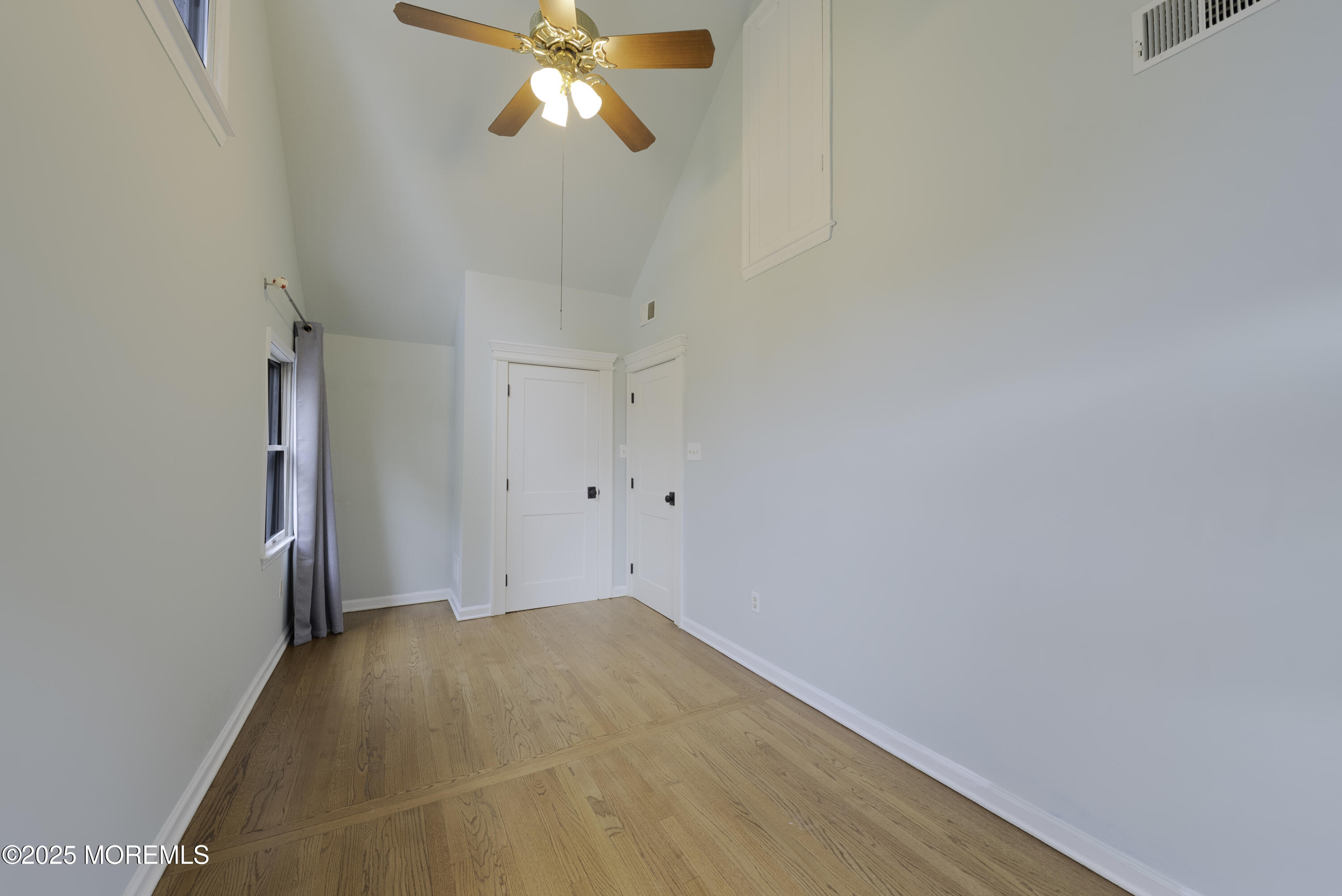 7 Allen Street Rumson, NJ 07760 - Photo 21 of 36 a view of a room with wooden floor and a ceiling fan