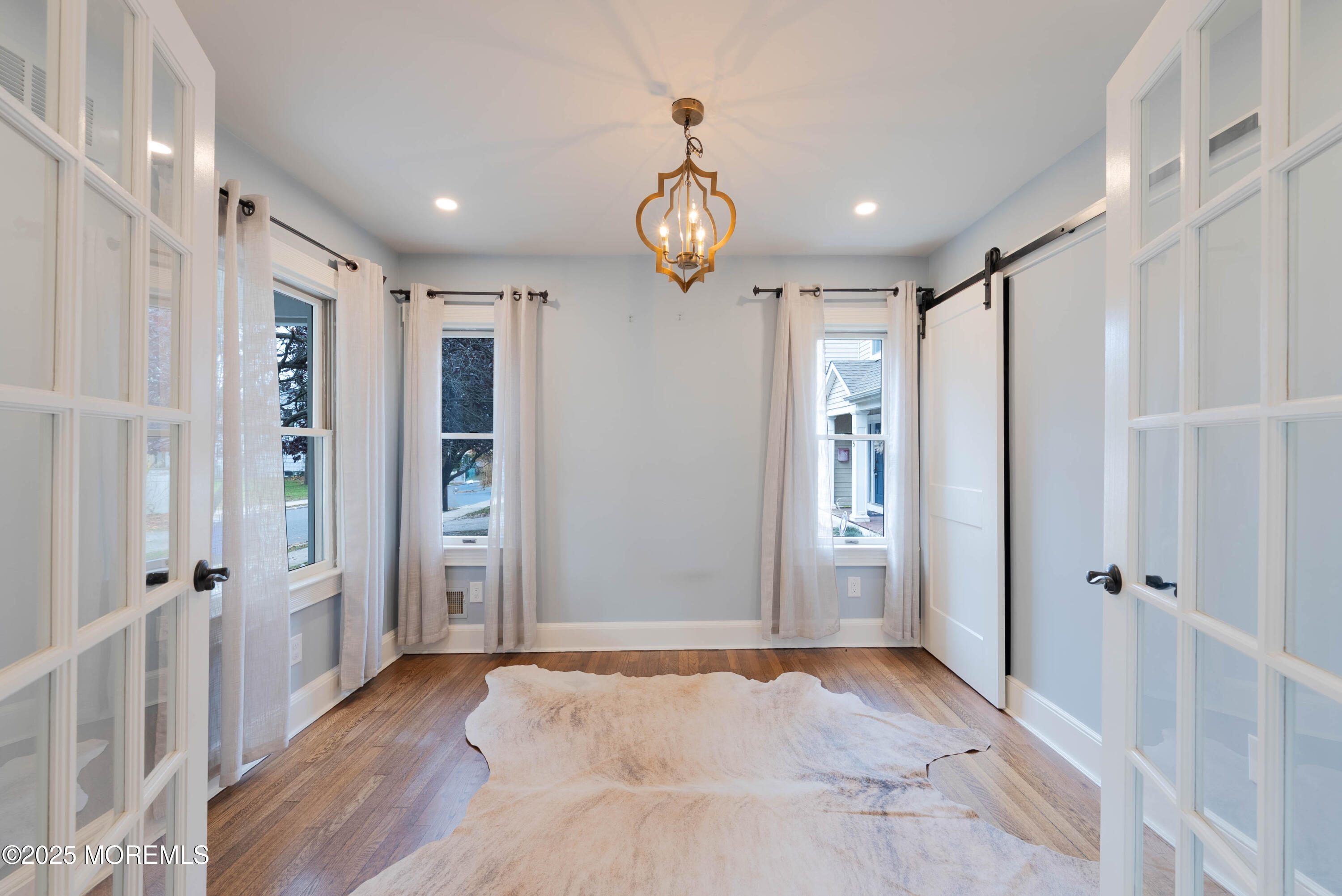 7 Allen Street Rumson, NJ 07760 - Photo 6 of 36 a view of an empty room with wooden floor and windows