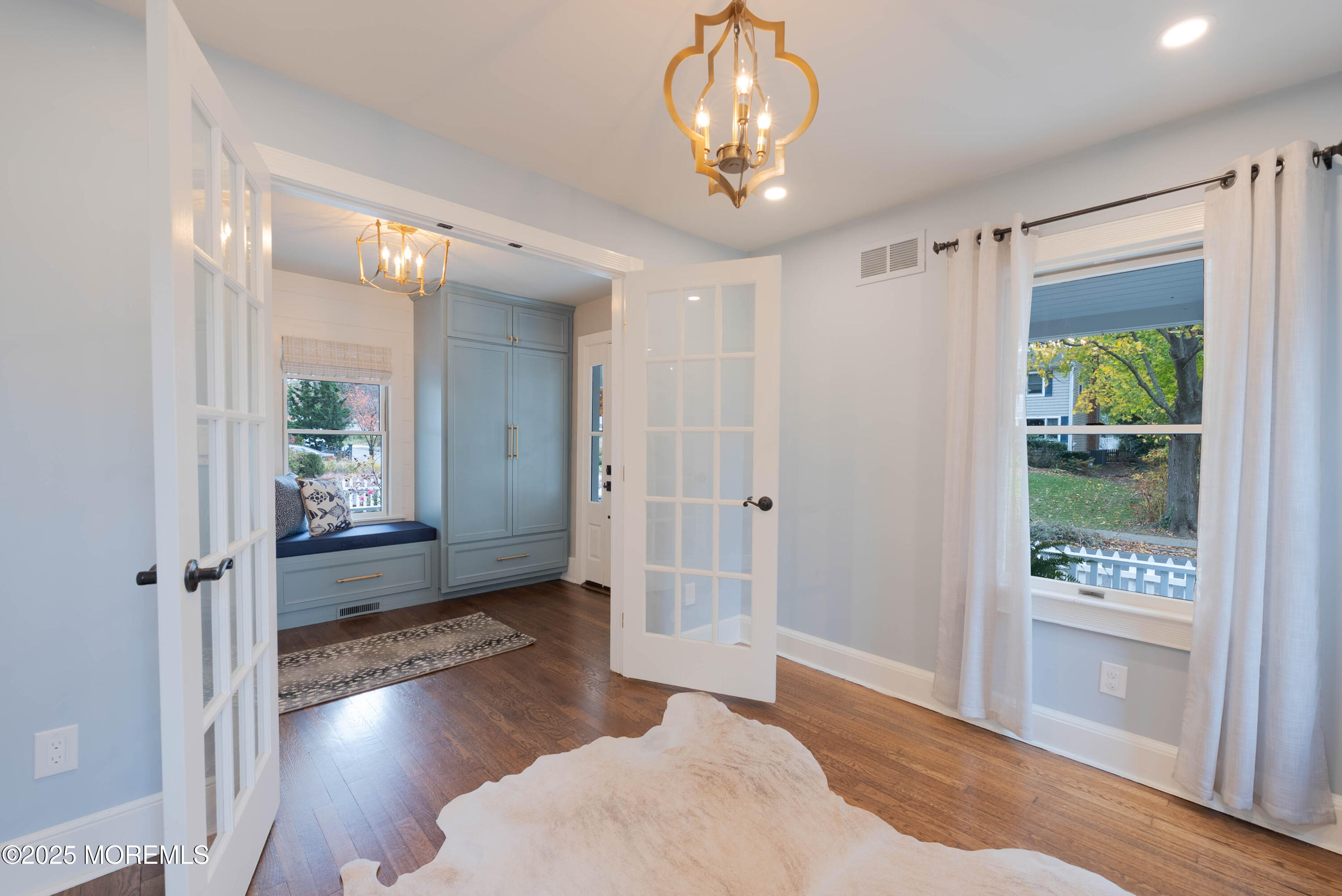 7 Allen Street Rumson, NJ 07760 - Photo 7 of 36 a living room with wooden floor and a chandelier