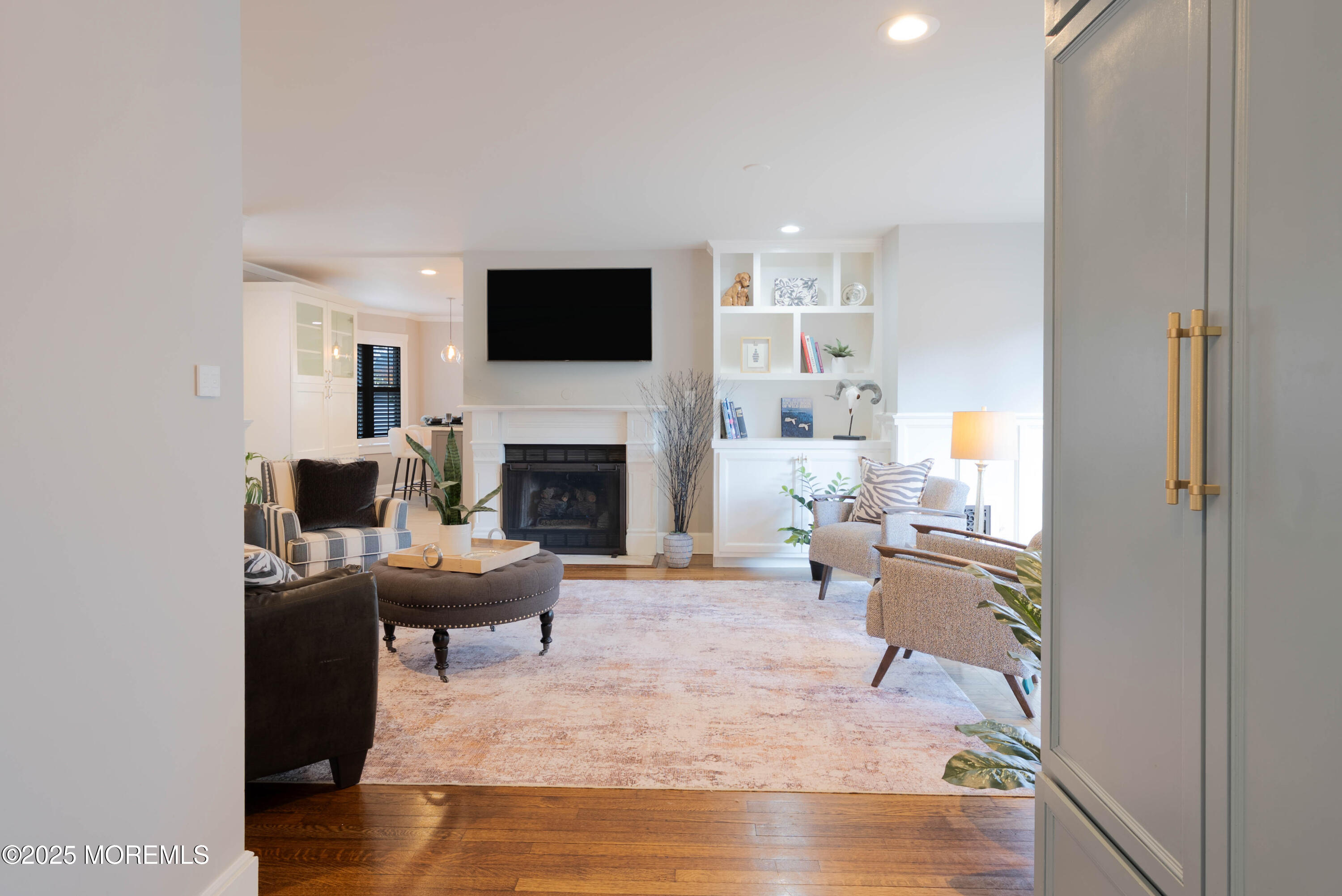 7 Allen Street Rumson, NJ 07760 - Photo 8 of 36 a living room with furniture a flat screen tv and a fireplace