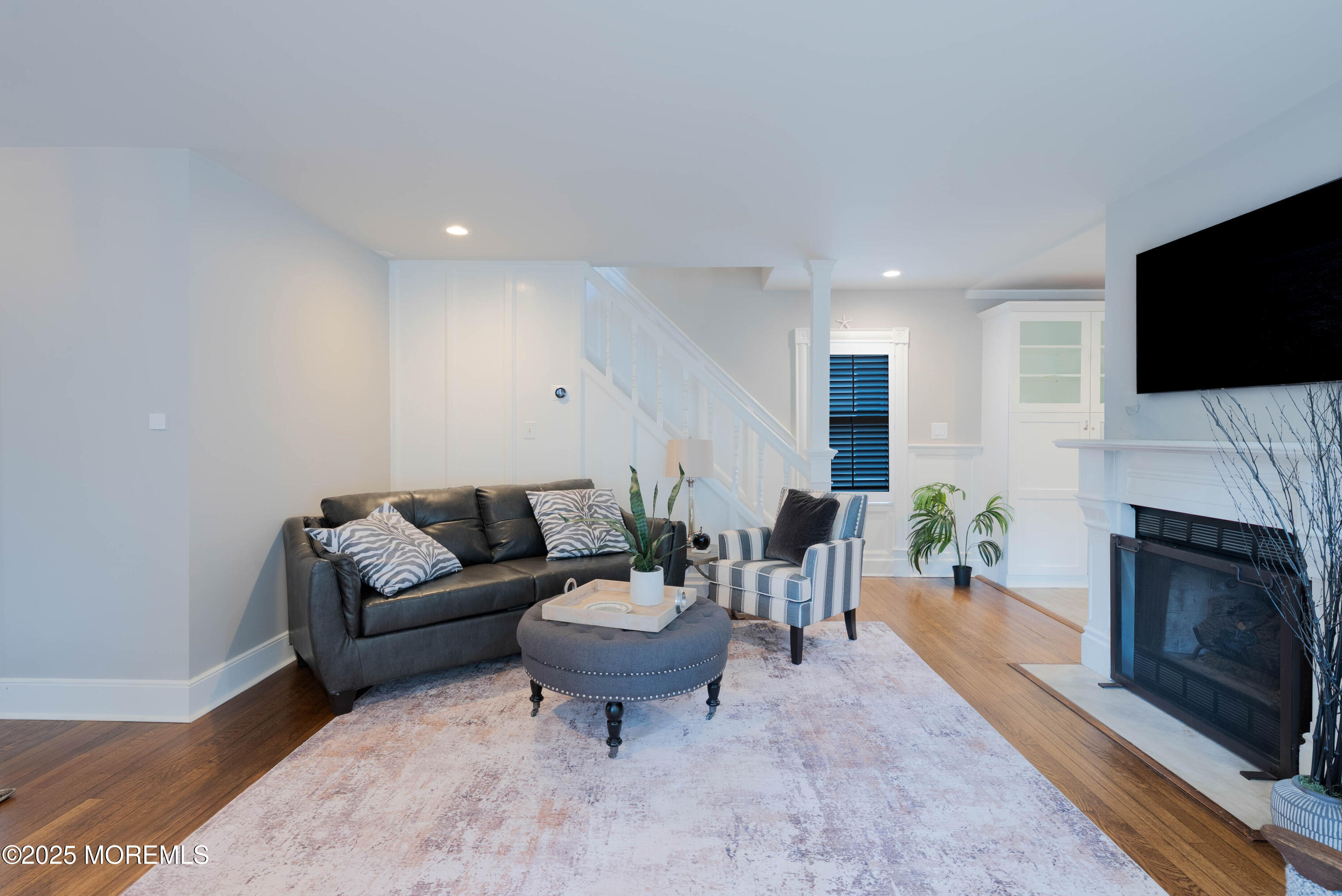 7 Allen Street Rumson, NJ 07760 - Photo 9 of 36 a living room with furniture a fireplace and a flat screen tv