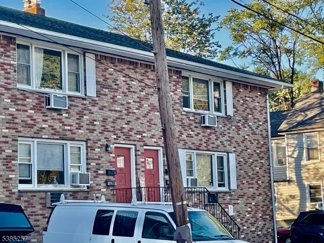 a front view of a house with parking area