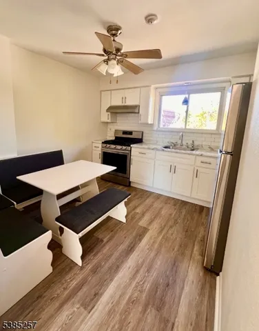 a kitchen with a sink appliances and cabinets
