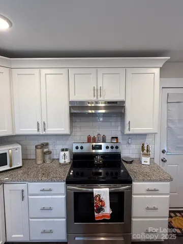 a stove top oven sitting inside of a kitchen