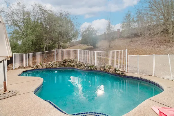 a view of a swimming pool with a patio