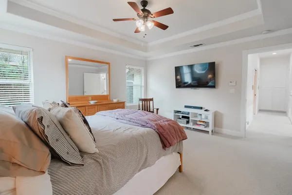 a bedroom with furniture and a wooden floor